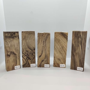 May include: Five pieces of wood with a brown and black wood grain pattern. The wood pieces are labeled 10.1, 10.2, 10.3, 10.4, and 10.5.