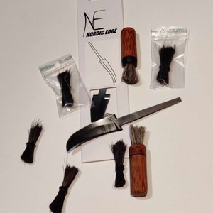 May include: A set of six small brushes with black handles and natural bristles. The brushes are packaged in clear plastic bags with the text "GRIPPIE" printed on them. The brushes are arranged on a white surface with a small knife and a package of a knife with the text "NORDIC EDGE" printed on it.