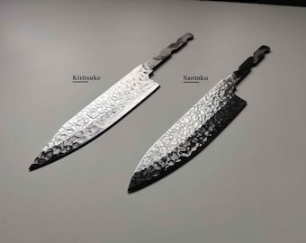 May include: Two silver-colored metal knife blades with a hammered texture. The left blade is labeled Kiritsuke and the right blade is labeled Santoku. Both blades feature a pointed tip and a tang extending from the handle end for attachment.