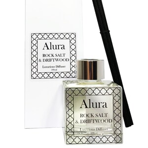May include: A clear glass diffuser bottle with a silver cap and black reeds. The bottle has a label that reads "Alura Rock Salt & Driftwood Luxurious Diffuser 100ml".