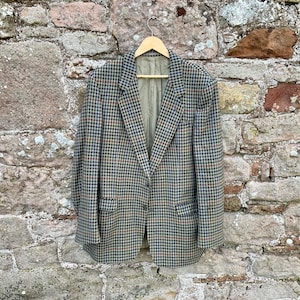 May include: A brown, blue, and beige plaid blazer with a single button closure.