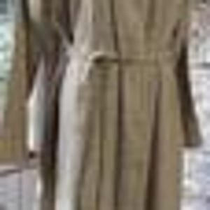 May include: A long, beige trench coat with a belt and button closure. The coat is made of a smooth, lightweight fabric.