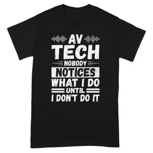 May include: Black t-shirt with white text that reads "AV TECH Nobody Notices What I Do Until I Don't Do It." The shirt has a crew neck and short sleeves. The text is in a bold, sans-serif font.