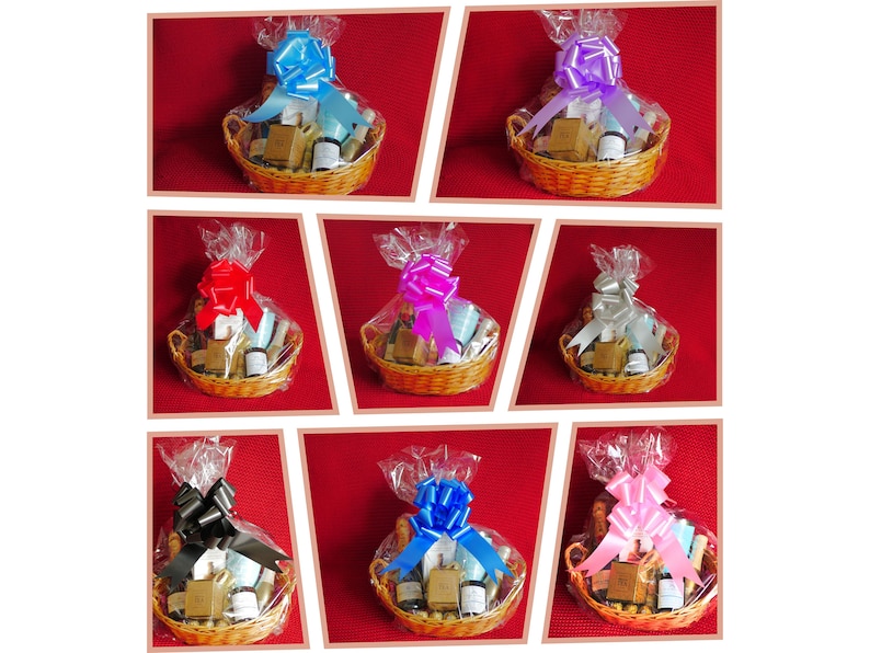 May include: Nine wicker baskets filled with various bath and body products, each wrapped in clear cellophane and tied with a different colored satin ribbon bow. The bows are black, blue, pink, purple, red, silver, and light blue.