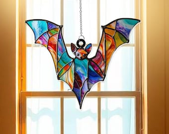 May include: A stained glass bat hanging from a chain. The bat is made of colorful glass with a rainbow of colors, including red, orange, yellow, green, blue, purple, and pink. The bat is a popular Halloween decoration.