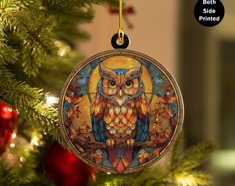 May include: Round Christmas ornament featuring a colorful owl design. The owl is perched on a branch, surrounded by autumn leaves, with a stained-glass effect. The ornament is double-sided, as indicated by the text "Both Side Printed".