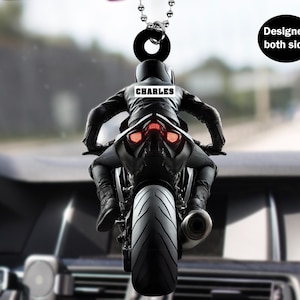 May include: Black motorcycle rear view mirror charm with the name "CHARLES" printed on the rider's jacket. Designed for both sides.