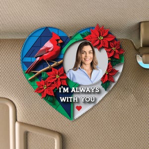 May include: A heart-shaped car charm with a red cardinal, poinsettia flowers, and a photo frame. The charm has the text "I'm always with you" and a small red heart.
