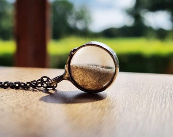 Tiny sand necklace, shaker pendant with moving sand from the Baltic.