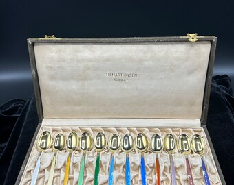 Thorvald Martinsen Norway set of 12 sterling silver guilloche enamel demitasse spoons in cloister pattern with gold wash.