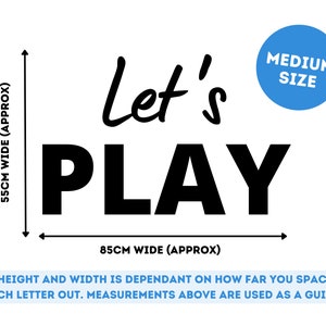 May include: Black and white wall decal with the text "Let's Play". The decal is 55 cm wide and 85 cm wide. The text is in a bold, playful font. The decal is labeled "Medium Size".
