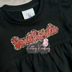 May include: Black sweatshirt with a red and gold "Southside" applique on the front. The applique is surrounded by a brown and white leopard print design.