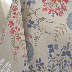 Table setting with wildflower Italian tablecloth, rustic French vintage style décor, dining room scene.