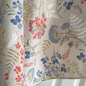 Full rectangle table view, wildflower print tablecloth, cozy farmhouse dining look.