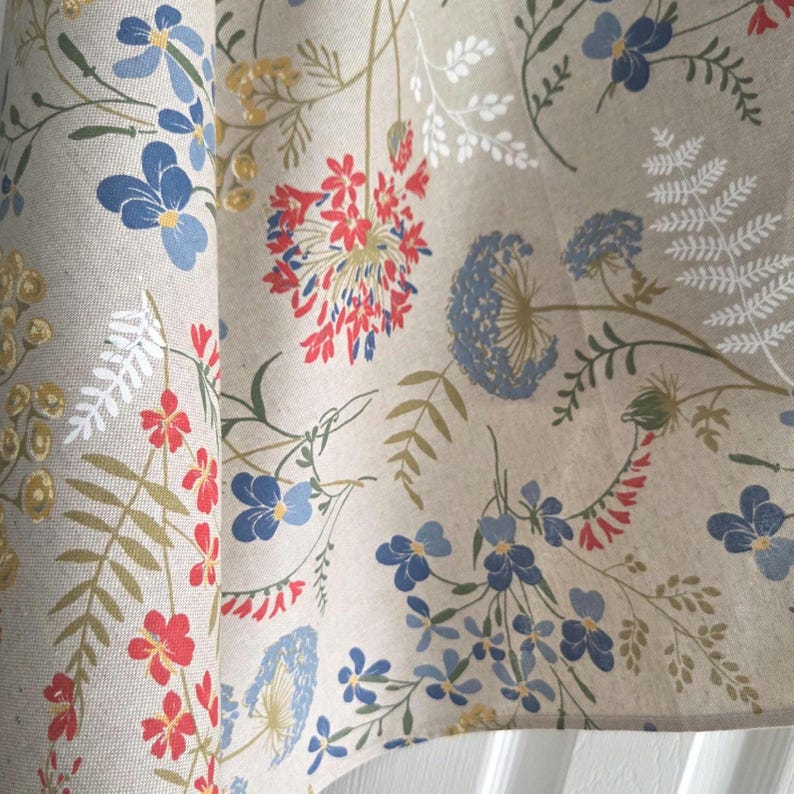 Full rectangle table view, wildflower print tablecloth, cozy farmhouse dining look.