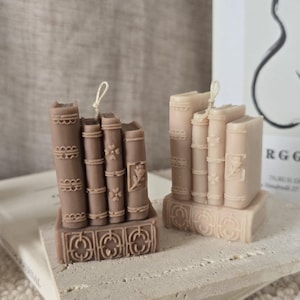 May include: A set of three ceramic mugs with a speckled, matte finish. The mugs are in cream, light grey, and dark grey. Each mug has a simple, minimalist design, ideal for coffee or tea.