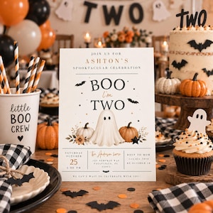 May include: A rectangular invitation card featuring a ghost illustration, pumpkins, and bats with the text: JOIN US FOR ASHTON'S SPOOKTACULAR CELEBRATION, BOO I'm TWO, SATURDAY OCTOBER 25 2:00 PM, The Anderson home 123 PUMPKIN WAY FALLSVILLE, FL 32003, RSVP TO MOM 123.456.7890 BY OCTOBER 18.