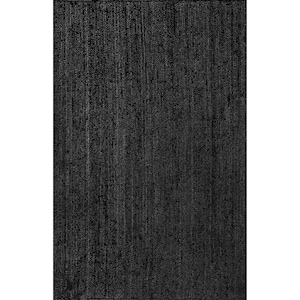 May include: A rectangular black rug with a woven texture. The rug's dark color and simple design make it suitable for various interior styles. The rug is made of a durable material.