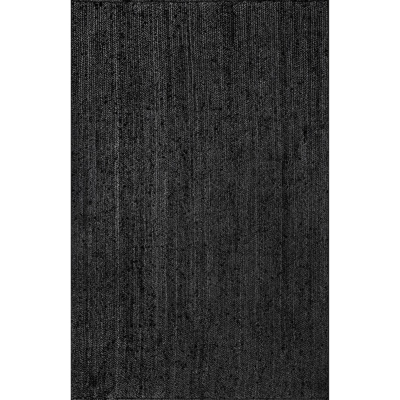 May include: A rectangular black rug with a woven texture. The rug's dark color and simple design make it suitable for various interior styles. The rug is made of a durable material.