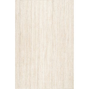 May include: A rectangular, neutral-toned rug with a woven texture. The rug's surface is composed of vertical, parallel lines, creating a subtle striped effect. The color is a light beige, suitable for various interior design styles.