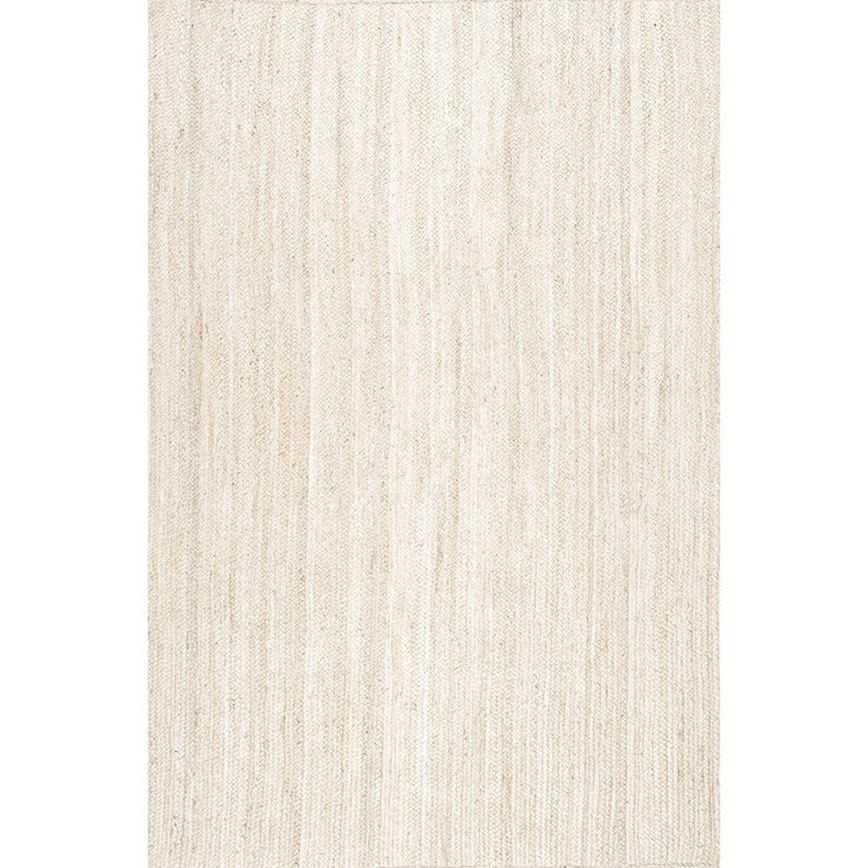 May include: A rectangular, neutral-toned rug with a woven texture. The rug's surface is composed of vertical, parallel lines, creating a subtle striped effect. The color is a light beige, suitable for various interior design styles.