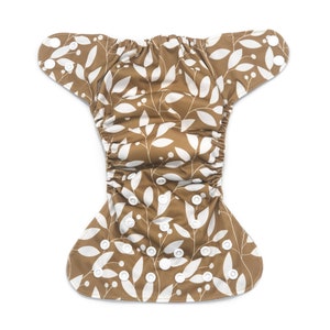 May include: A brown cloth diaper with a white leaf and berry pattern. The diaper has adjustable snaps and a waterproof outer layer.