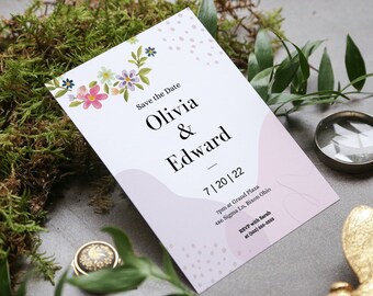 Puede incluir: Tarjeta de guardar la fecha con ilustraciones florales y lunares rosas y blancos. La tarjeta dice "Save the Date Olivia & Edward 7|20|22 7pm at Grand Plaza 486 Sigma Ln, Bixon Ohio RSVP with Sarah at (555) 555-5555"