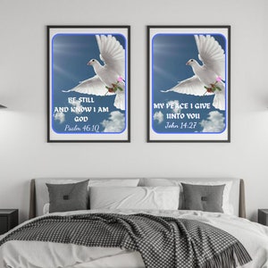 May include: Two framed prints with white doves flying against a blue sky background. The prints feature inspirational quotes from the Bible: "Be still and know I am God" (Psalm 46:10) and "My peace I give unto you" (John 14:27).
