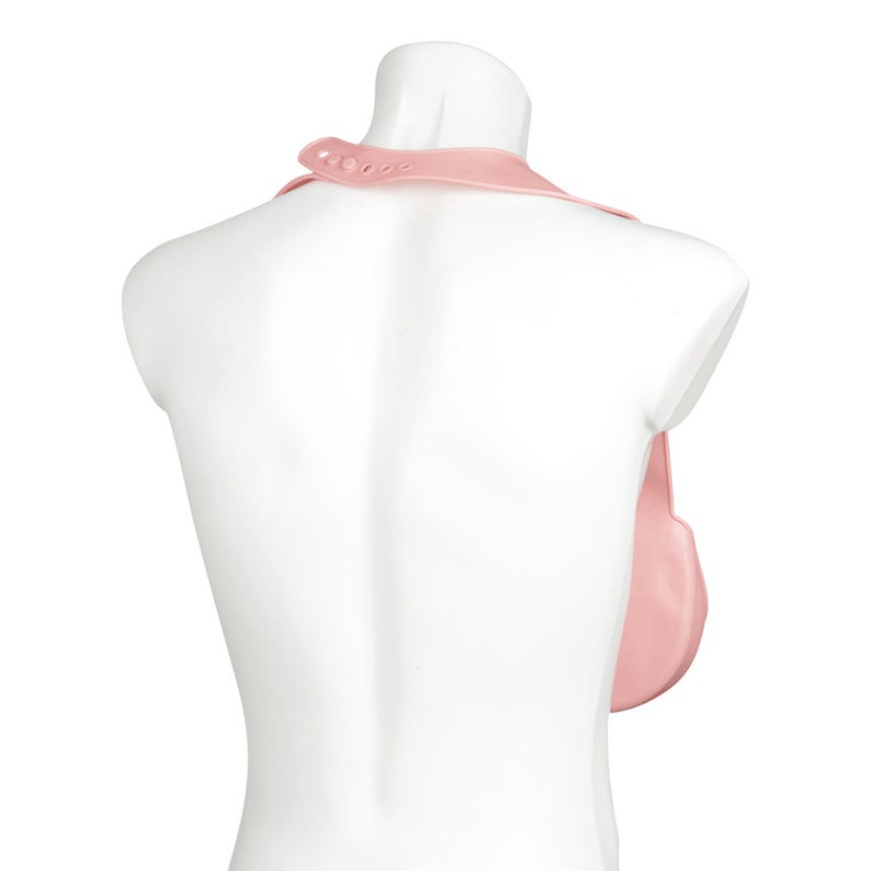 May include: A pink silicone bib with a neck strap and a large pocket in the front. The bib is designed to catch food and spills.