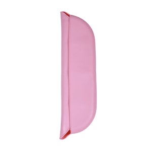 May include: A pink silicone bib with a curved shape and a fold-over design.