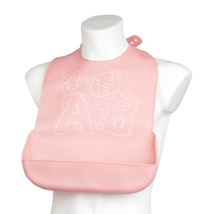 May include: Pink silicone baby bib with a white outline of two bears holding the letters A and B.