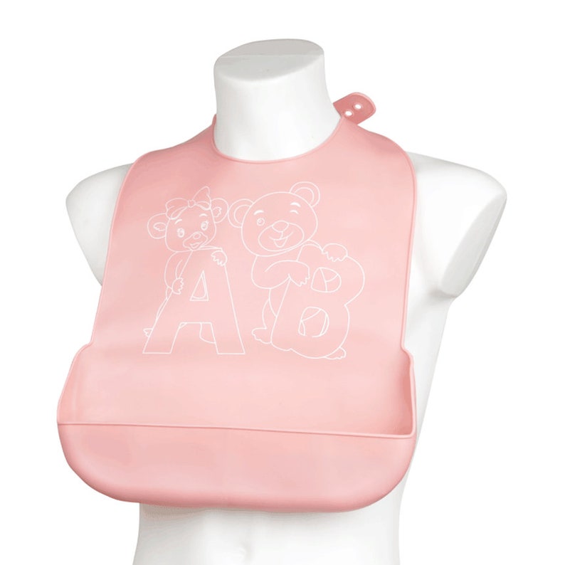 May include: Pink silicone baby bib with a white outline of two bears holding the letters A and B.