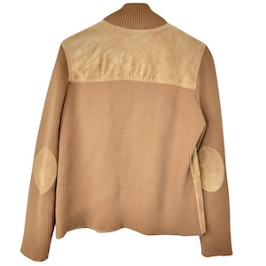 May include: A brown ribbed knit sweater with suede elbow patches and a suede collar.