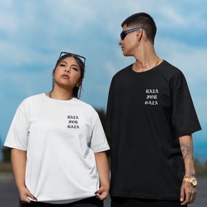 May include: Two people wearing black and white t-shirts with the text "Raza for Gaza" printed on them. The person on the left is wearing a white t-shirt and the person on the right is wearing a black t-shirt.