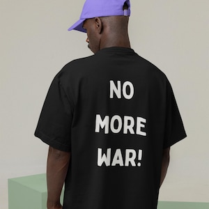 戦争反対Tシャツ、反戦Tシャツ、平和Tシャツ、戦争反対抗議Tシャツ、私の名においてではない、ピースサインTシャツ、爆弾を止めろ