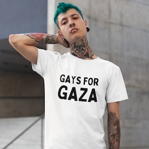 May include: A white t-shirt with the text "GAYS FOR GAZA" printed in black.