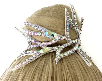 May include: A silver hair comb with iridescent rhinestones in a butterfly design.