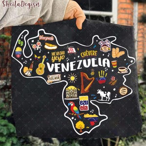 May include: Black tote bag featuring a white outline of Venezuela, filled with colorful illustrations of Venezuelan culture. Includes text that reads "Venezuela", "Me Va Dar Yeyo", and "Ch&eacute;vere".