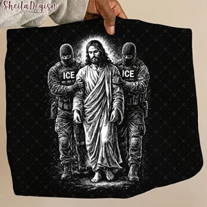 May include: Black and white graphic art print featuring Jesus Christ flanked by two figures in tactical gear, each with "ICE" printed on their uniforms. The artwork is set against a black background.