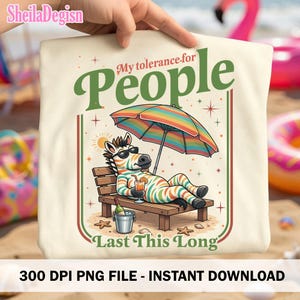 Puede incluir: Una bolsa de mano crema con una ilustración de una cebra relajándose en una silla de playa bajo una sombrilla arcoíris. El texto dice "My tolerance for People Last This Long".