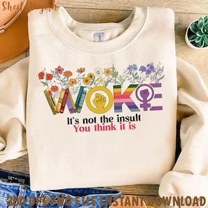 Pu&ograve; includere: Una felpa bianca con un design grafico che dice "WOKE" in lettere arcobaleno con fiori e libri che circondano la parola. Il testo sotto la grafica dice "Non &egrave; l'insulto che pensi".