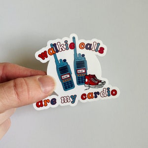 May include: A white sticker with the text "walkie calls are my cardio" in colorful, rounded letters. The sticker features two blue walkie talkies and a pair of red sneakers.