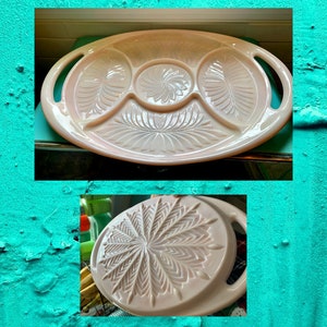 May include: A vintage pink serving tray with three divided sections. The tray has a raised, floral design and two handles.