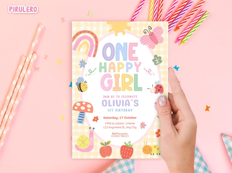 May include: A pastel-colored birthday invitation with the text "ONE HAPPY GIRL" and "OLIVIA'S 1ST BIRTHDAY". The design includes a rainbow, butterfly, bee, mushroom, ladybug, snail, apple, strawberry, and caterpillar. The invitation is held by a hand.