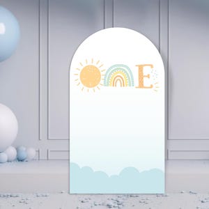 May include: A white arch backdrop with a blue, green, and orange rainbow, a yellow sun, and the letter "E" in orange. The backdrop is decorated with white clouds and a light blue sky.