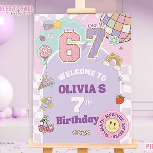 May include: A colorful birthday sign with the text "Welcome to Olivia's 7th Birthday." The sign features the numbers "6" and "7" with decorative elements like a rainbow, ice cream cone, and a smiley face.