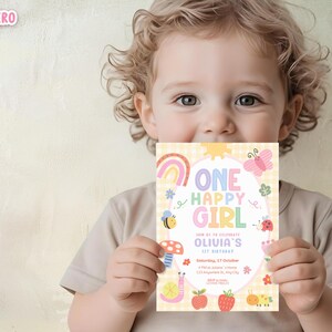 May include: A child holds a colorful invitation with the text "ONE HAPPY GIRL" and details for a 1st birthday celebration. The design includes a rainbow, butterfly, bee, and other whimsical illustrations on a yellow gingham background.