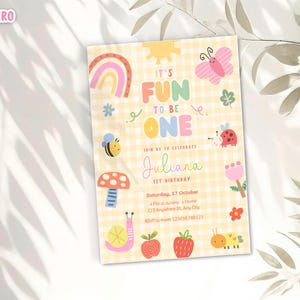 May include: A colorful birthday invitation with the text "It's Fun to Be One" and the name "Juliana". The design includes a rainbow, sun, butterfly, bee, ladybug, mushroom, snail, apple, strawberry, and caterpillar.