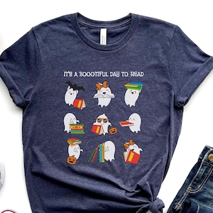 May include: A heather navy blue t-shirt with the text "It's a Bootiful Day to Read" and a graphic of ghosts reading books.