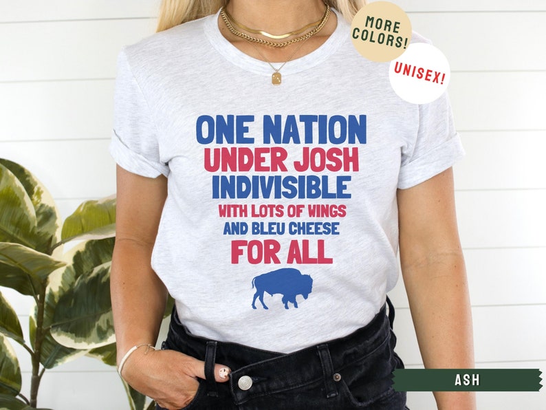 May include: A gray t-shirt with the text "One Nation Under Josh Indivisible with lots of wings and bleu cheese for all" in red, blue, and white. A blue buffalo silhouette is below the text.